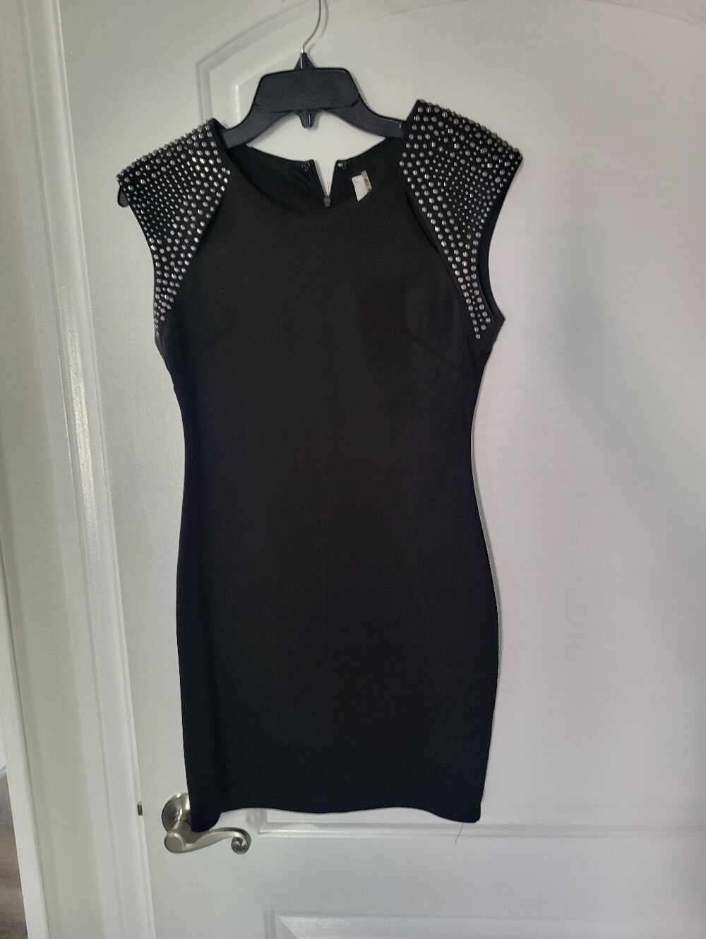 short Black fitted size small zip back dress with Stud details
